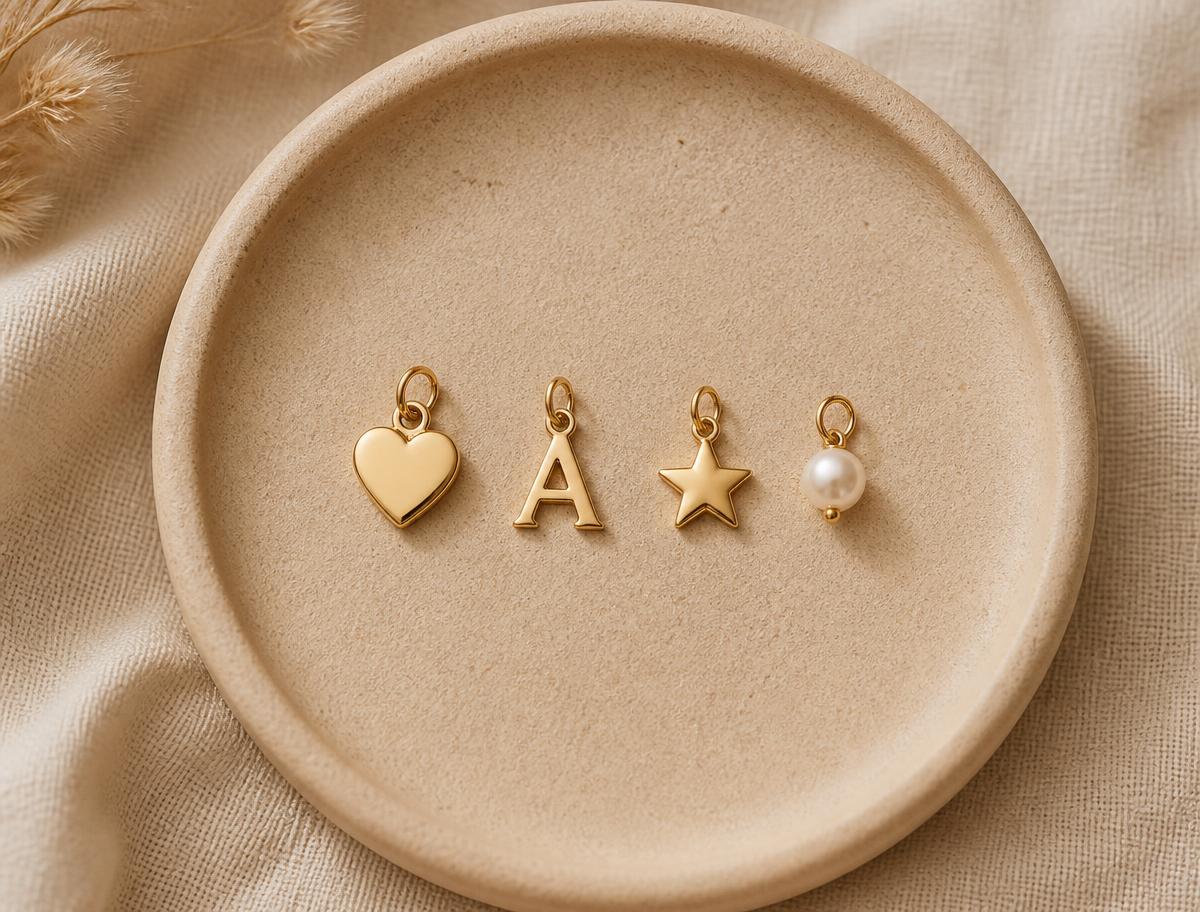 Gold charms laid out on a sand tray
